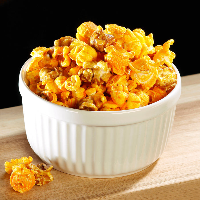 caramel and cheese mix popcorn displayed in a white serving bowl