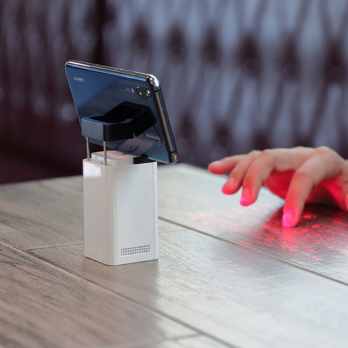 Virtual laser projection keyboard displaying full-size QWERTY keys on a flat surface, Bluetooth wireless and portable typing device